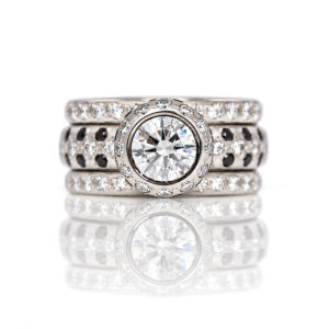 Modern platinum solitaire ring with 1.5ct natural white diamond and black and white diamond halo