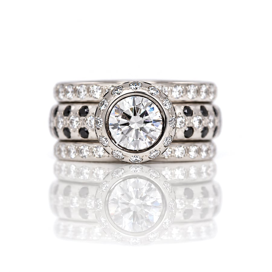 Modern platinum solitaire ring with 1.5ct natural white diamond and black and white diamond halo