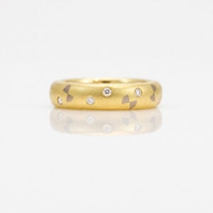 Flush set dimaonds in gold ring with bow tie pattern 0290A