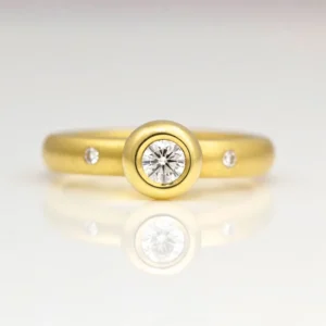 Rub-over diamond solitaire in 18ct yellow gold