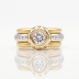 Rub-over set natural diamond set in yellow gold with flush set diamonds in Platinum stacking rings 0852