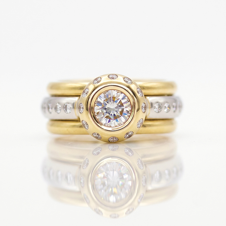 Rub-over set natural diamond set in yellow gold with flush set diamonds in Platinum stacking rings 0852