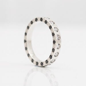 Unique eternity ring black and white natural diamonds flush set on three sides