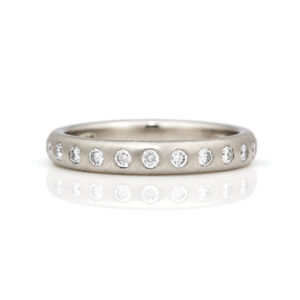Platinum ring with evenly flush set diamonds