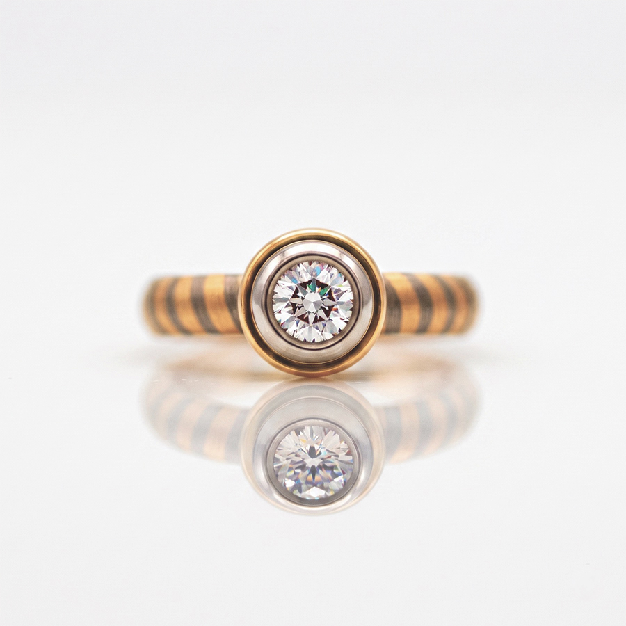rub-over set diamond engagement ring with unique 18ct yellow and white gold stripe band David Ashton 0952