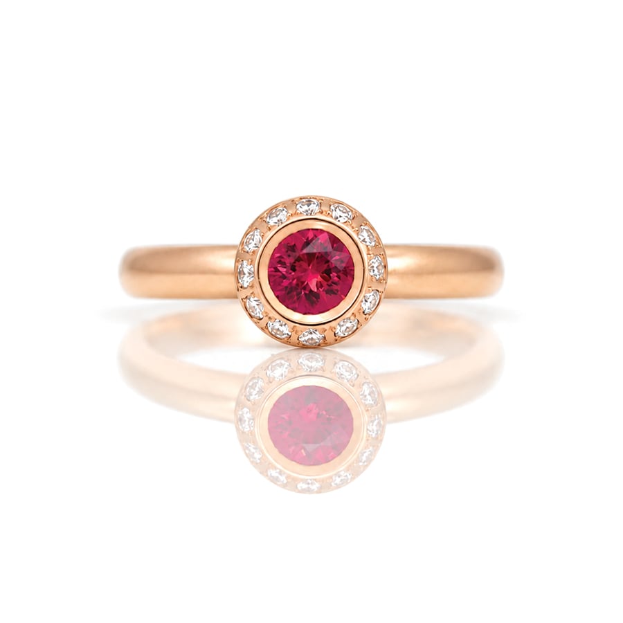 Burmese ruby rub-over set framed with diamonds in 18ct rose gold ring