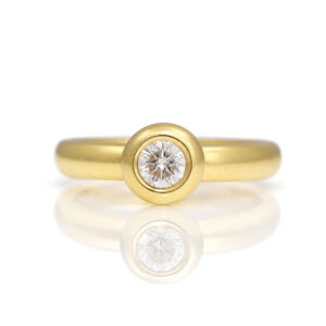 18ct yellow gold ring with a rub-over set diamond solitaire