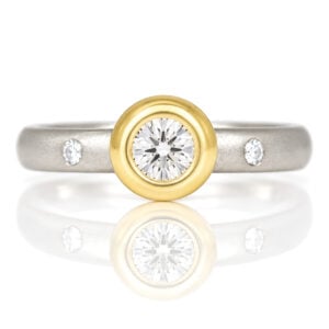 Elegant diamond ring with gold bezel