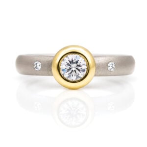 Elegant diamond ring with gold bezel