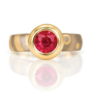 modern ruby solitaire rub-over set in gold, yellow and white gold patterned ring David Ashton Jewellery