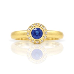 Modern sapphire and diamond yellow gold engagement