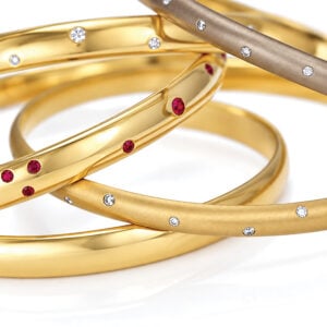 Handmade solid 18ct gold bangles with flush set natural gemstones and diamonds. David Ashton