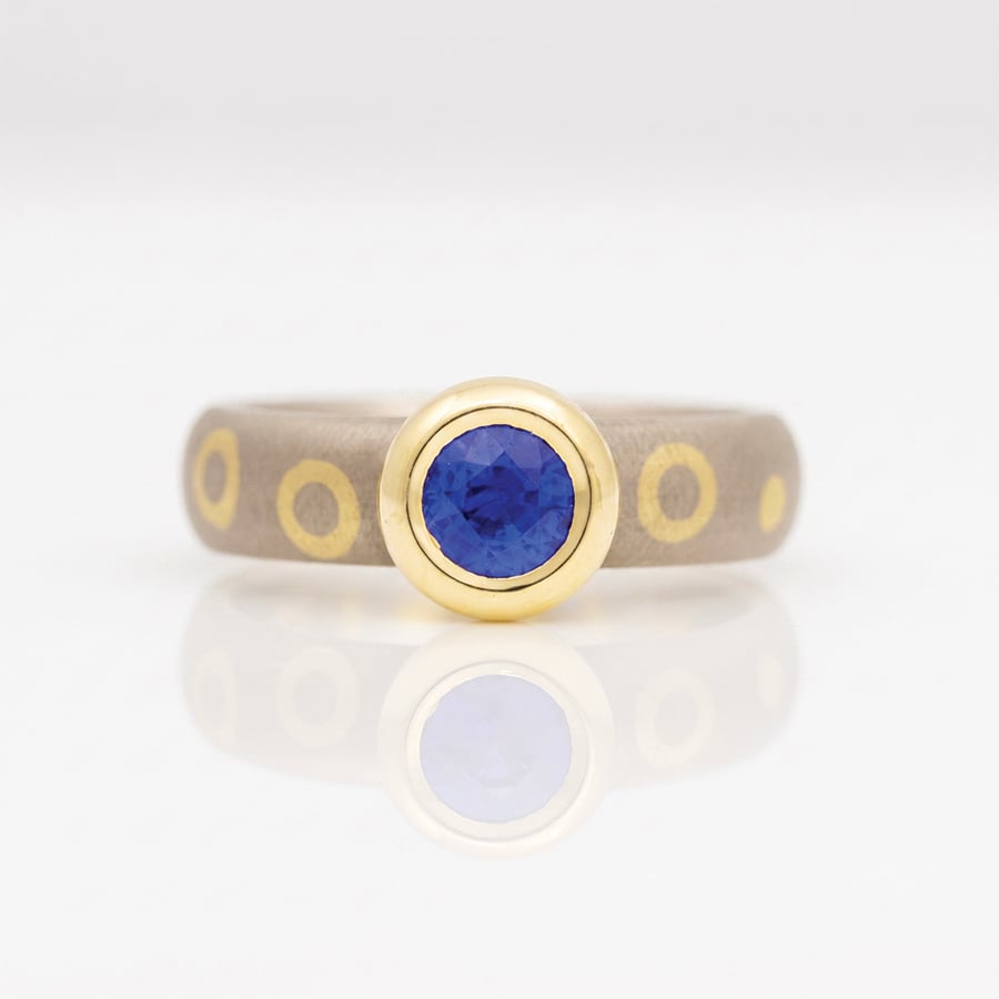 Sapphire rub-over on dot and circle ring