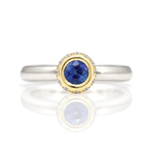 modern sapphire solitaire with diamond halo ring David Ashton
