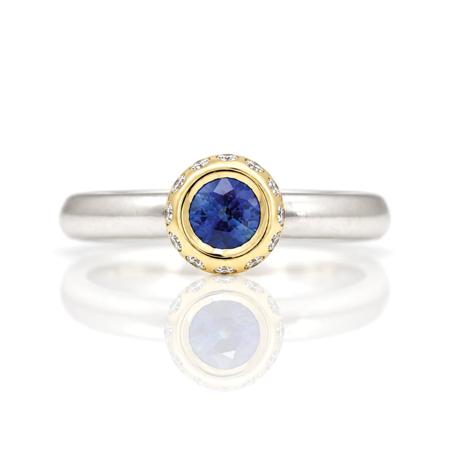 modern sapphire solitaire with diamond halo ring David Ashton