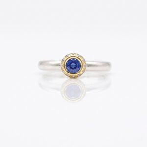 modern sapphire solitaire with diamond halo ring David Ashton