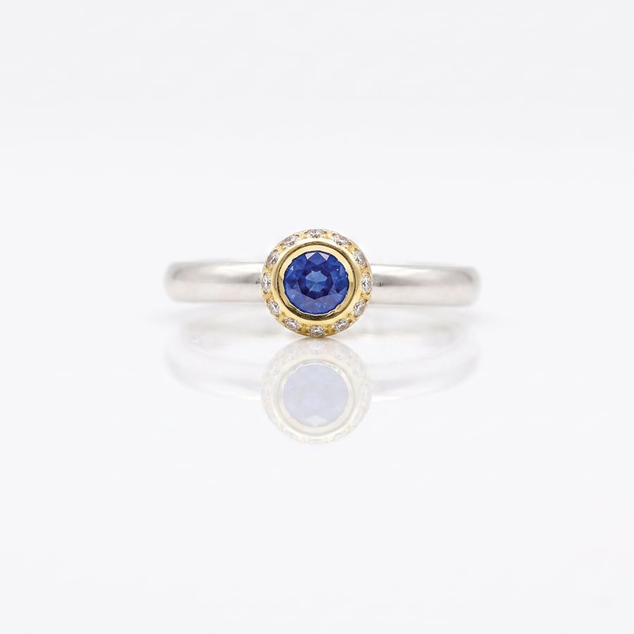 modern sapphire solitaire with diamond halo ring David Ashton