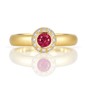 Burmese ruby ring in yellow gold with diamonds.