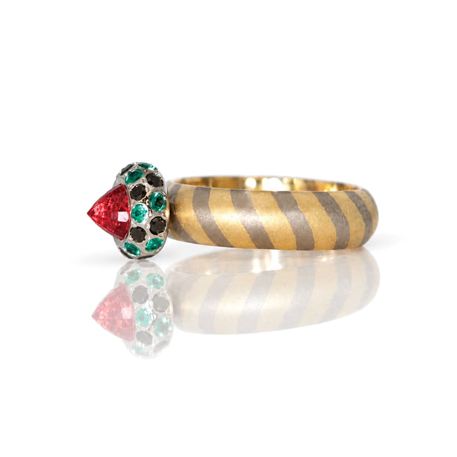 Modern orange sapphire framed with emeralds and black diamonds on diagonal stripe 18ct gold ring