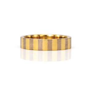 A flat profile ring with yellow and white stripes