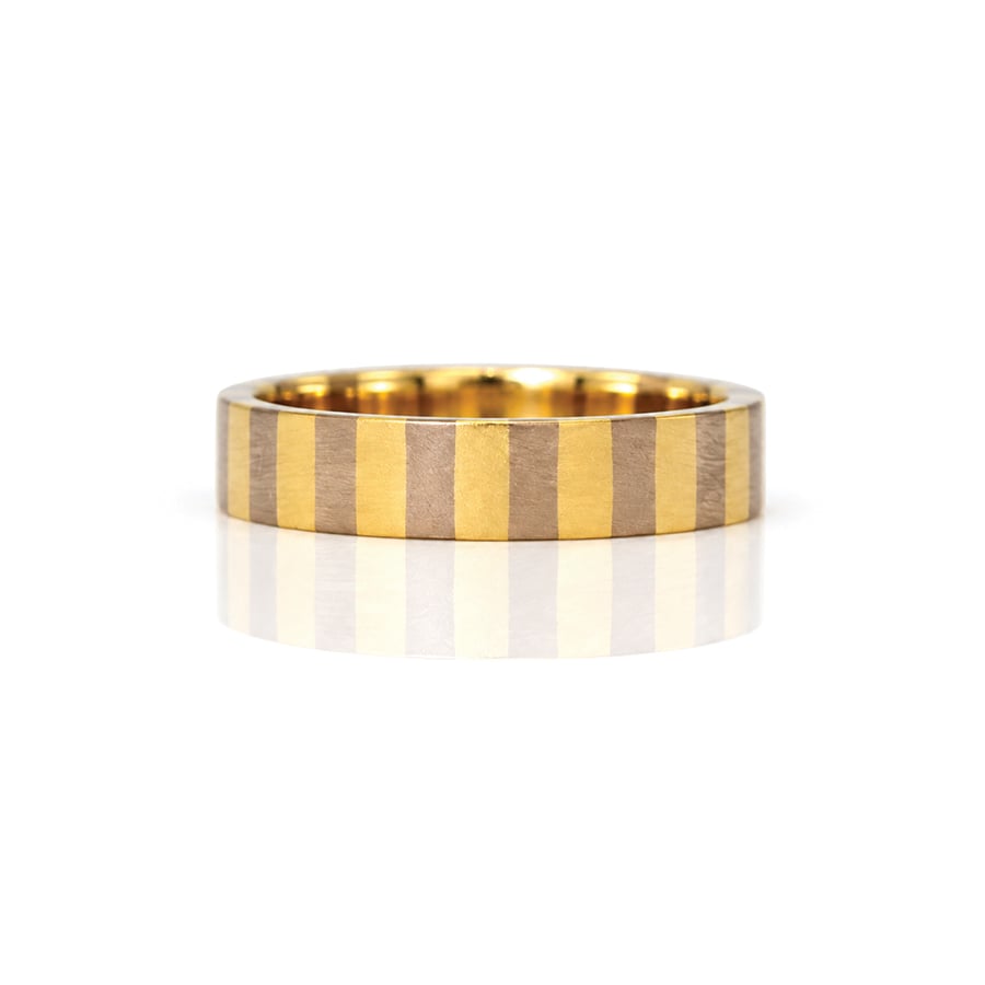 A flat profile ring with yellow and white stripes