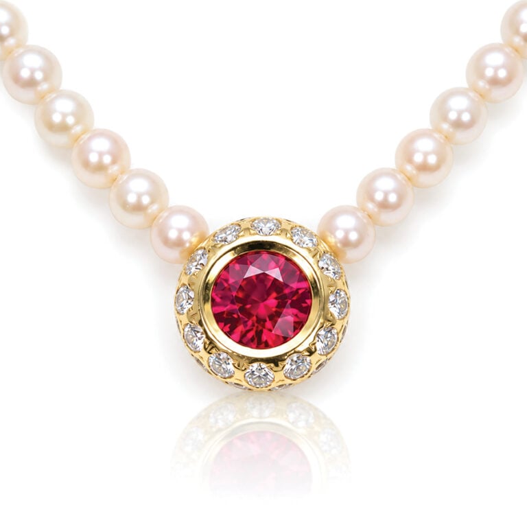 Perfect red ruby, framed with diamonds, ona strang of AAA paerls necklace