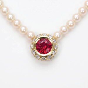 Burmese ruby necklace, with diamond halo.