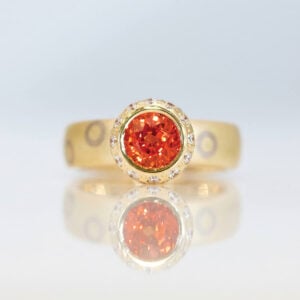 Orange sapphire ring with circles