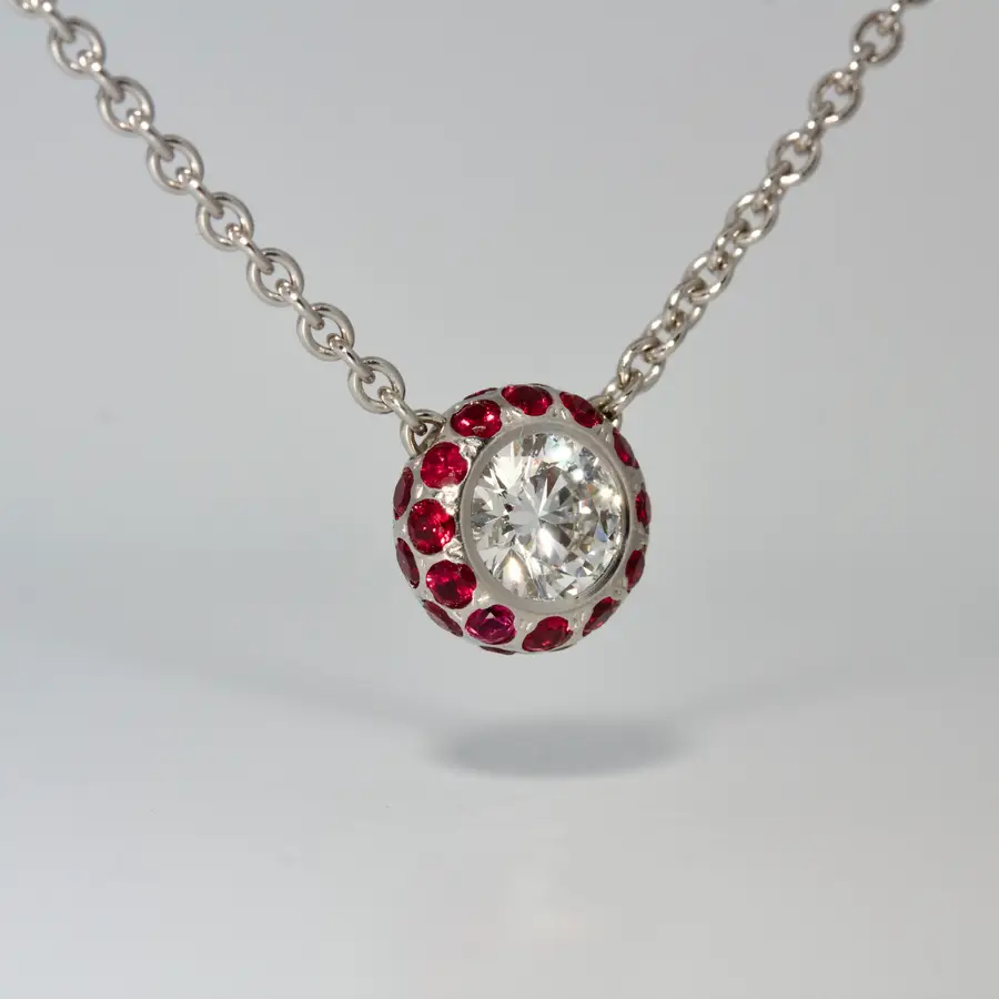 Fine natural diamond set in Platinum with natural rubies pendant. Modern fine jewellery handmade in London bespoke