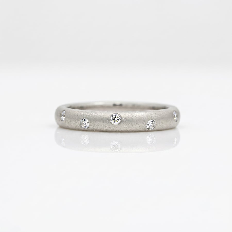 Diamonds randomly flush set Platinum. ring 0812 David Ashton