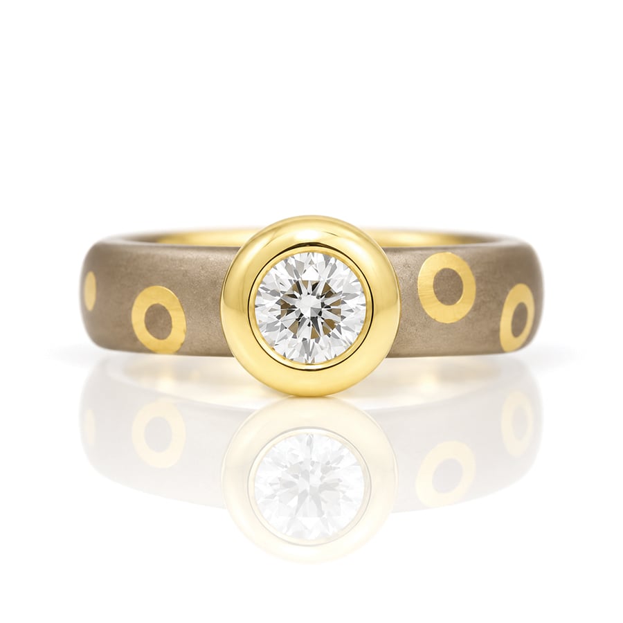 Modern diamodn engagement ring with a gold dotty band 0937