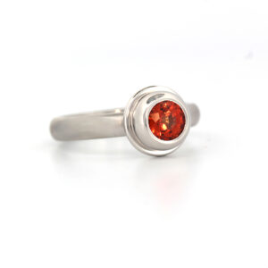 Orange sapphire set in Platinum ring